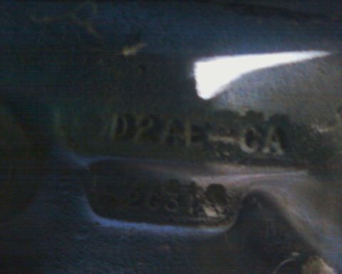 1976 Ford Torino - Close-up of a vehicle identification number plate with stamped characters.
