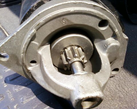 1976 Ford Torino - A close-up view of a starter motor, showing its pinion gear and mounting bracket. Text from a watermark is visible.