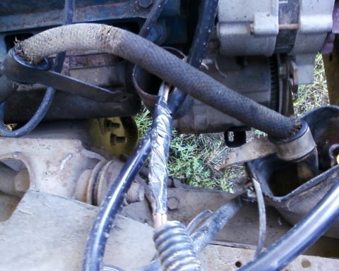 1976 Ford Torino - Close-up of engine components including hoses and alternator.