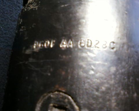 1976 Ford Torino - A metal component displays stamped identification numbers, possibly a part number or casting code.