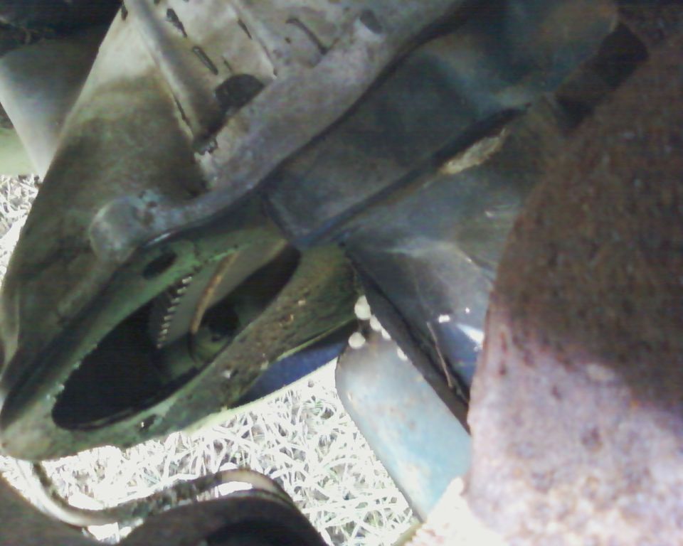 Starter motor engaging flywheel teeth on a vehicle's underside