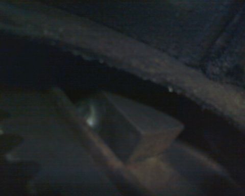1976 Ford Torino - This image shows a close-up of a mechanical component, likely part of a vehicle's undercarriage.