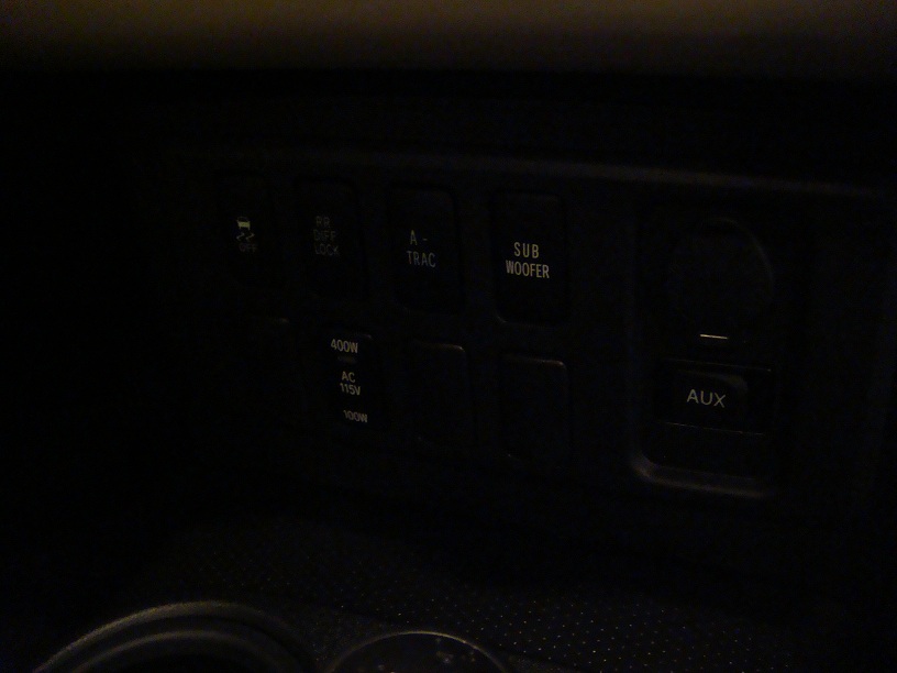Dashboard buttons for OFF, RR DIFF LOCK, A-TRAC, SUB WOOFER, 400W, AC 115V, 100W, and AUX