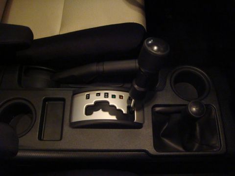 2010 Toyota FJ Cruiser - The center console of the vehicle displays the automatic transmission shifter and a separate 4WD selector.