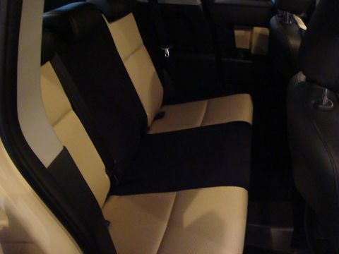 2010 Toyota FJ Cruiser - The interior of a vehicle shows black and tan seats with a dark trim.