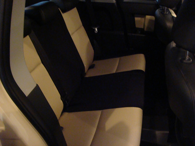 Car interior with two-tone black and tan seats, viewed from the side