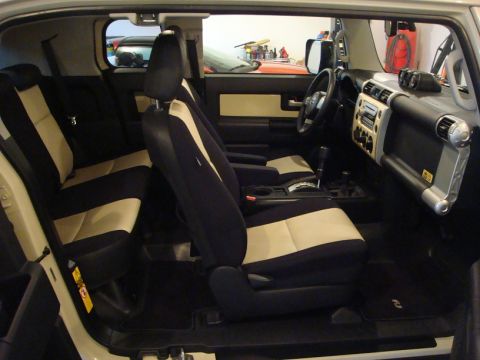 2010 Toyota FJ Cruiser - Interior of a 2010 Toyota FJ Cruiser, two-tone seats and a functional dashboard layout.
