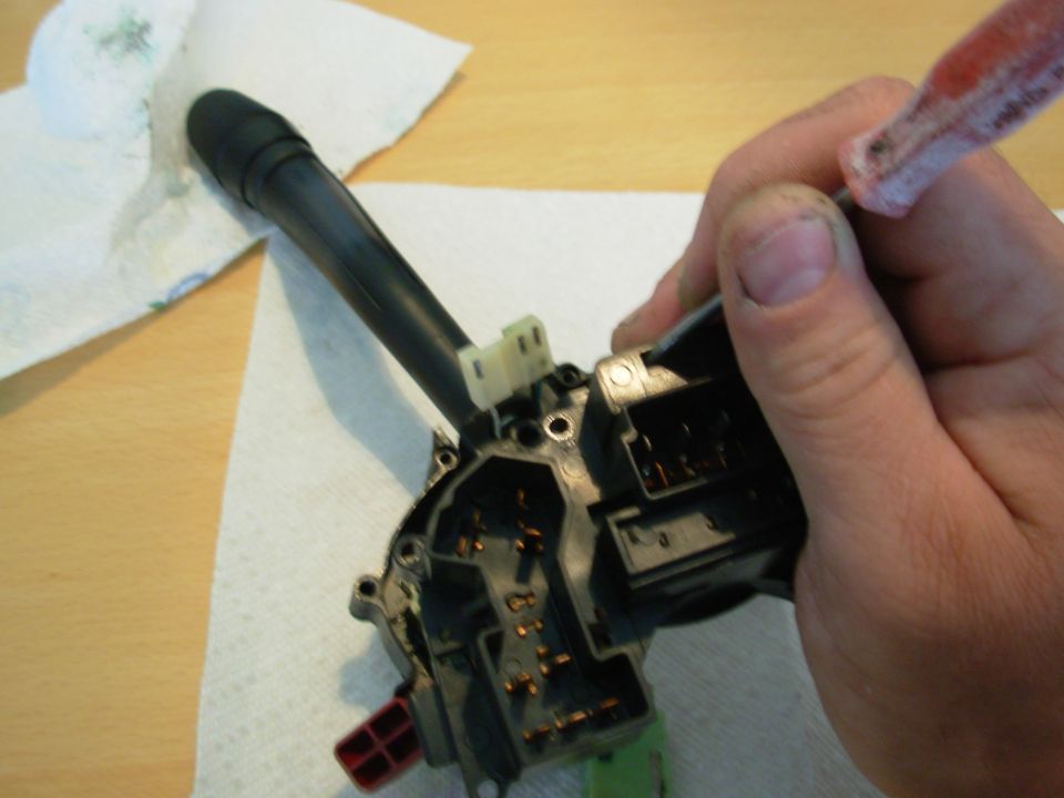 While splitting the case, release the catch on the wiper connector using a fine flat screwdriver or probe through this access hole.  It will still take some force to pull the front case up off the connector, and the lever MUST be held down against the rear case half.