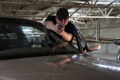 2000 Mercury Grand Marquis - Man aims handgun from inside a 2000 Mercury Grand Marquis during a garage meet.