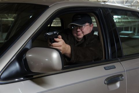 2000 Mercury Grand Marquis - Man points handgun from inside a 2000 Mercury Grand Marquis.