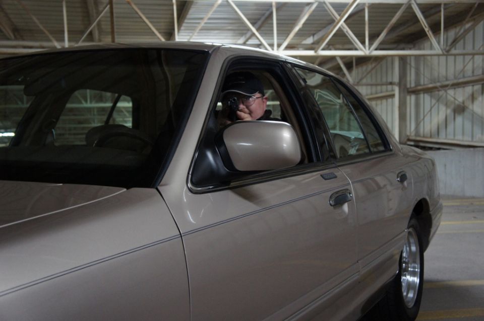 Tan sedan, looks like a 2000 Mercury Grand Marquis, parked inside