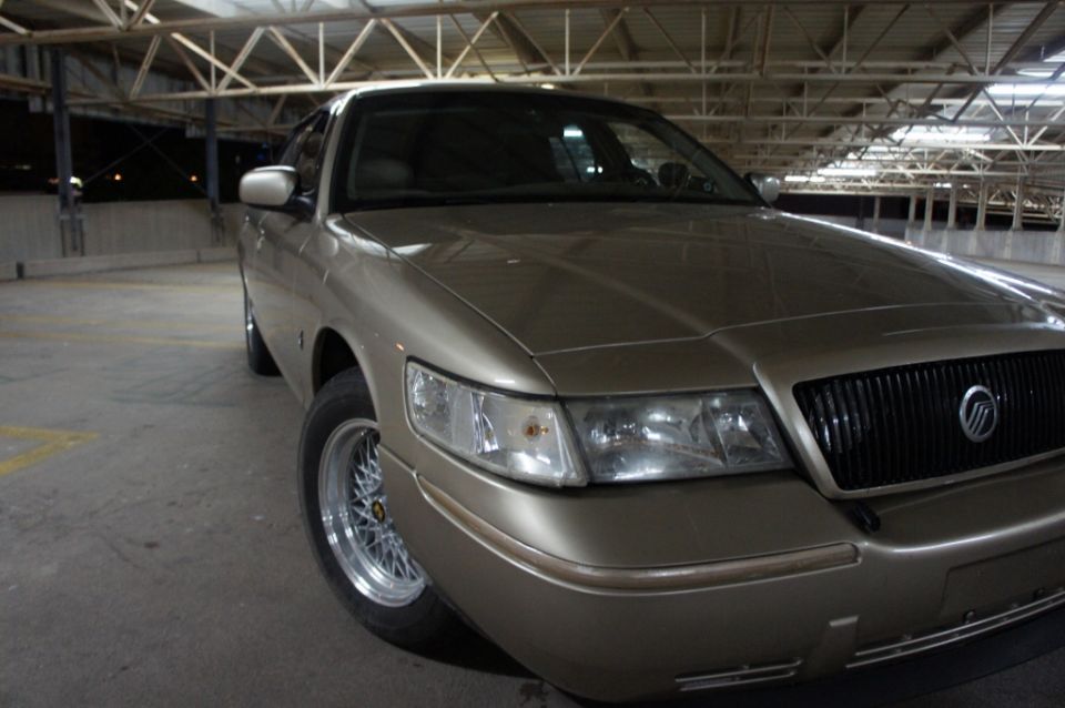 Gold 2000 Mercury Grand Marquis parked indoors