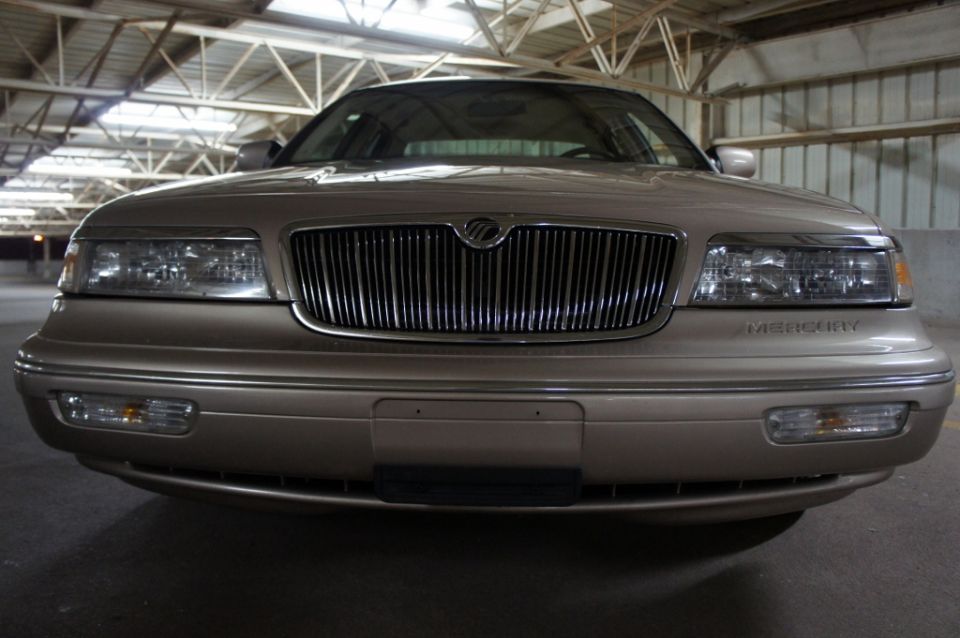Front view of a tan 2000 Mercury Grand Marquis parked indoors