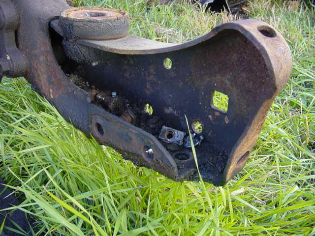 Rusted metal suspension part on grass