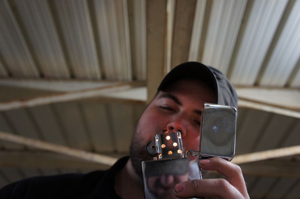 Man lighting a Zippo lighter