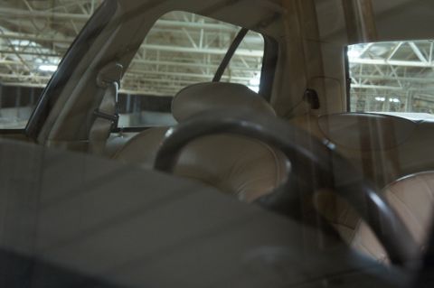 2000 Mercury Grand Marquis - Interior view of a car's tan seats and steering wheel.