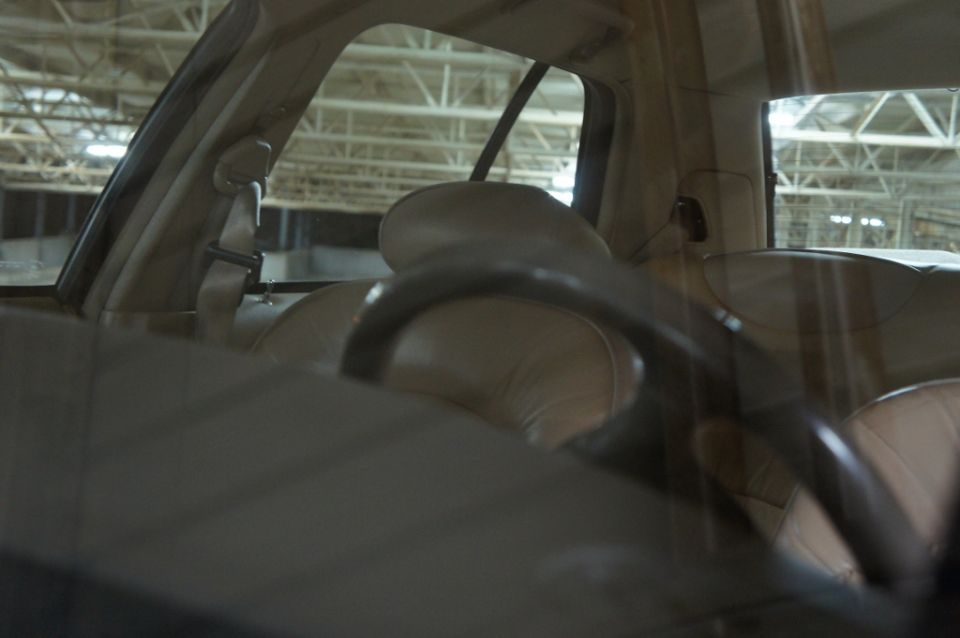 Interior view of a car showing tan seats and steering wheel