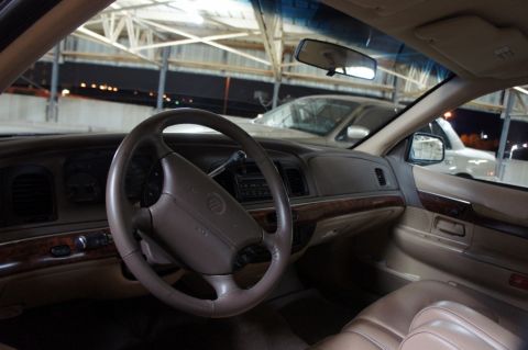 2000 Mercury Grand Marquis - The interior of a 2000 Mercury Grand Marquis is shown, with another vehicle visible through the windshield.