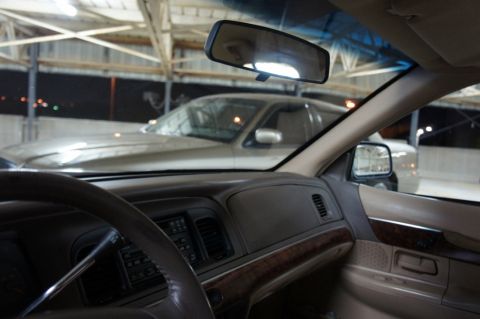 2000 Mercury Grand Marquis - Interior of a 2000 Mercury Grand Marquis, parked indoors with another vehicle visible.