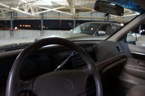 2000 Mercury Grand Marquis - The interior of a 2000 Mercury Grand Marquis is shown, with another vehicle visible through the windshield.