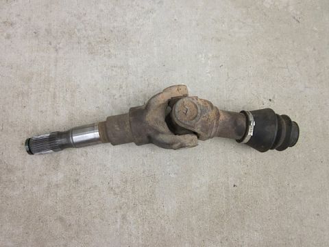 1985 Ford Bronco - A single driveshaft component is shown against a concrete background.