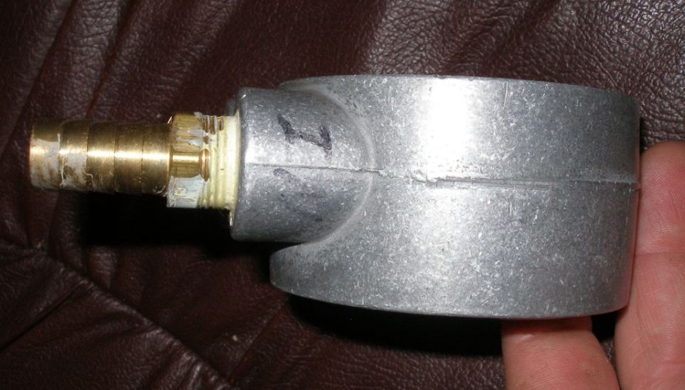 Metal housing with brass fitting, possibly an oil filter component