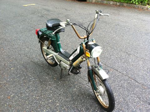 1981 Garelli Rally Sport - This green Garelli moped features chrome fenders, a rear cargo rack, and distinctive handlebars.