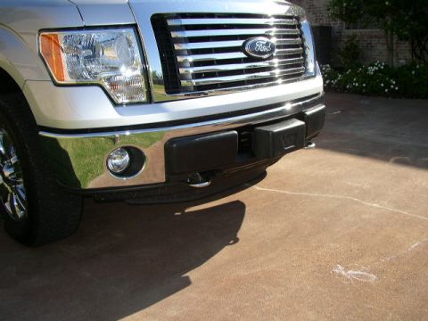 1995 Ford Bronco - Close-up of the front grille and bumper of a 2011 Ford F-150.