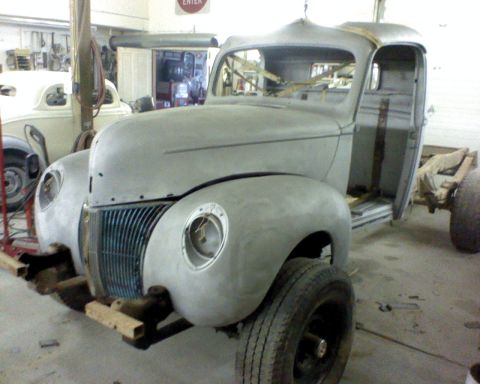 1978 Ford F-150 - This is a truck body in a garage, it is primer gray and has no windows, engine, or doors.