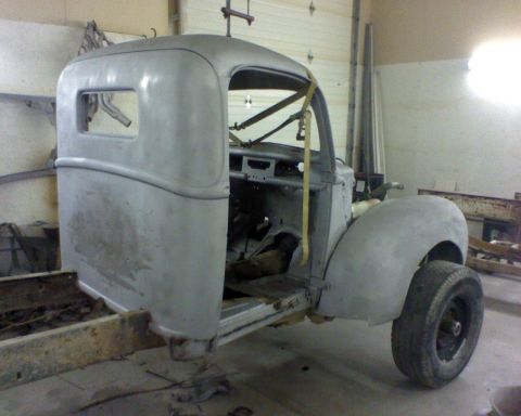 1978 Ford F-150 - A bare metal truck cab and chassis sits in a workshop, awaiting restoration.