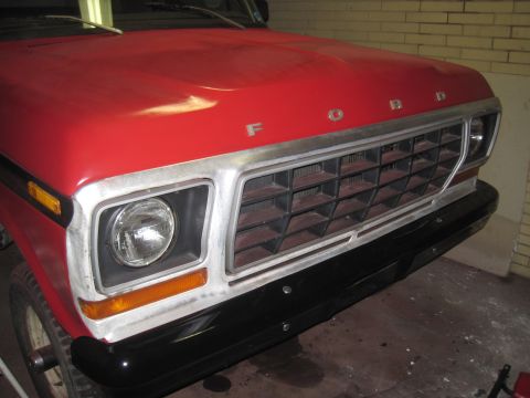 1979 Ford Bronco - Front view of a 1979 Ford Bronco, showing its distinctive grille and red hood.