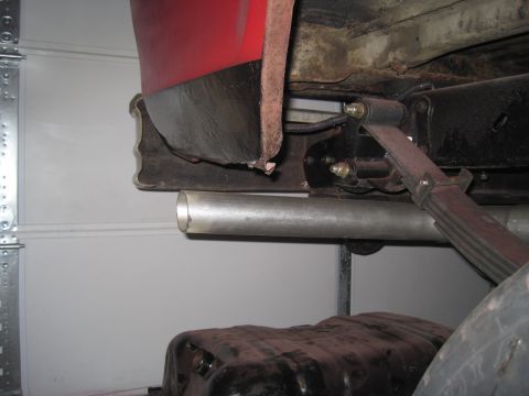 1979 Ford Bronco - Close-up view of the undercarriage of a vehicle, focusing on the exhaust system and suspension components.