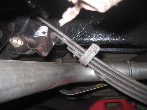 1979 Ford Bronco - Close-up view of vehicle undercarriage components, including leaf springs and exhaust pipe.