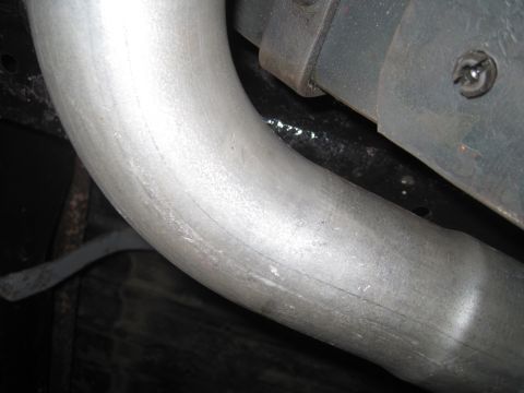 1979 Ford Bronco - Close-up view of a vehicle's exhaust pipe, with the Supermotors.net logo visible at the bottom right.