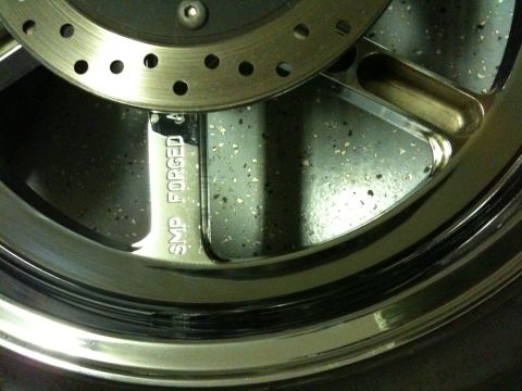 1996 Ford Bronco - Detail of a chrome wheel and brake rotor, showing 'SMP FORGED' inscription.
