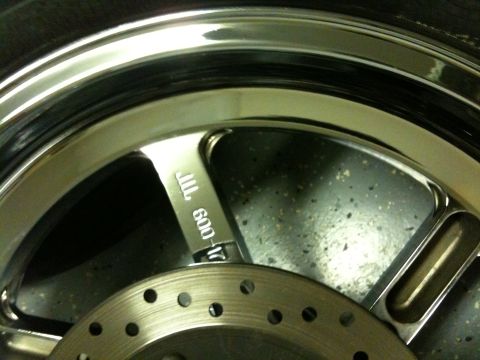 1996 Ford Bronco - Close-up of a chrome wheel and brake rotor with visible stamping.