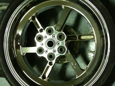 1996 Ford Bronco - Close-up of a shiny chrome motorcycle wheel, a six-bolt hub and a visible disc brake assembly.