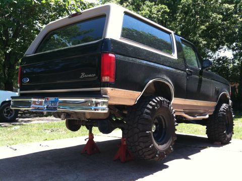 1996 Ford Bronco - This 1996 Ford Bronco is shown from the rear, elevated on jack stands for maintenance.