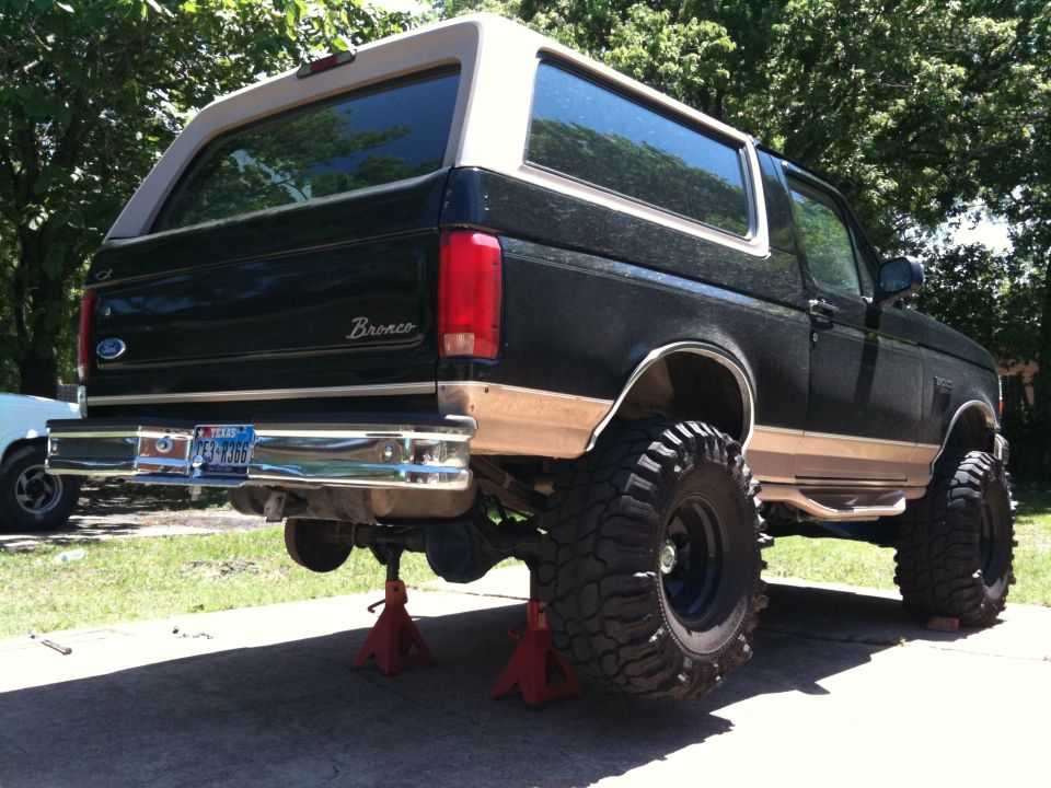 1996 Ford Bronco rear view, lifted on jack stands with large tires