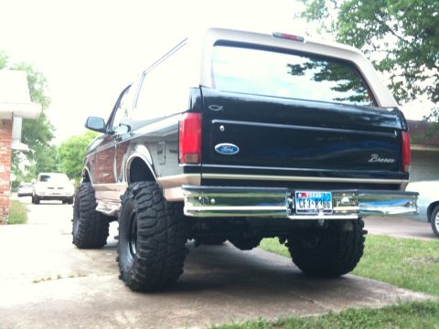 1996 Ford Bronco - Rear view of a lifted 1996 Ford Bronco with oversized tires and a custom license plate.
