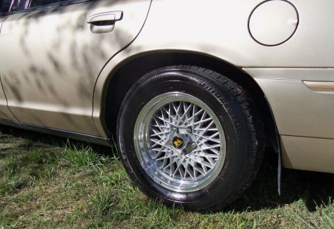 2000 Mercury Grand Marquis - Close-up of the rear wheel and fender of a 2000 Mercury Grand Marquis.