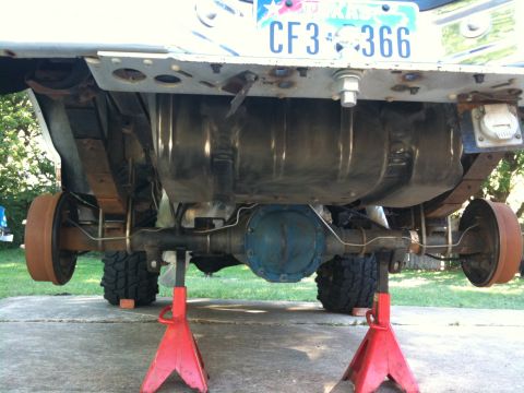 1996 Ford Bronco - Undercarriage view of a vehicle, showing the rear axle, fuel tank, and suspension components.