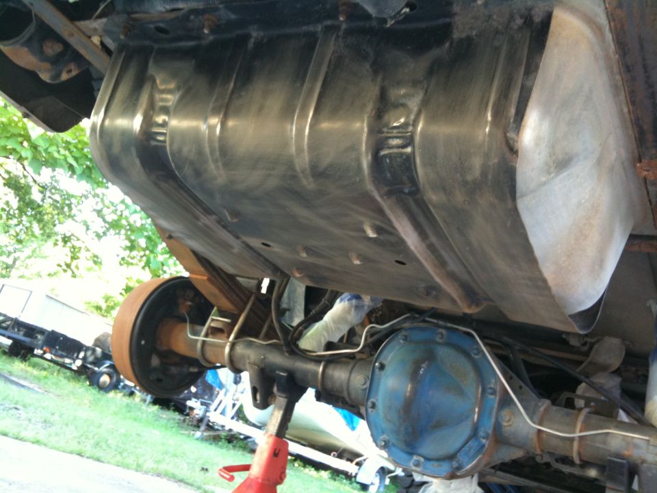 Undercarriage view showing fuel tank, rear axle, and drum brake assembly