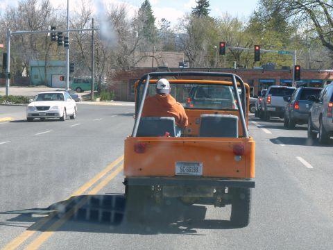 2006 Ford E350 - An orange jeep is seen from behind in traffic, with a license plate visible.