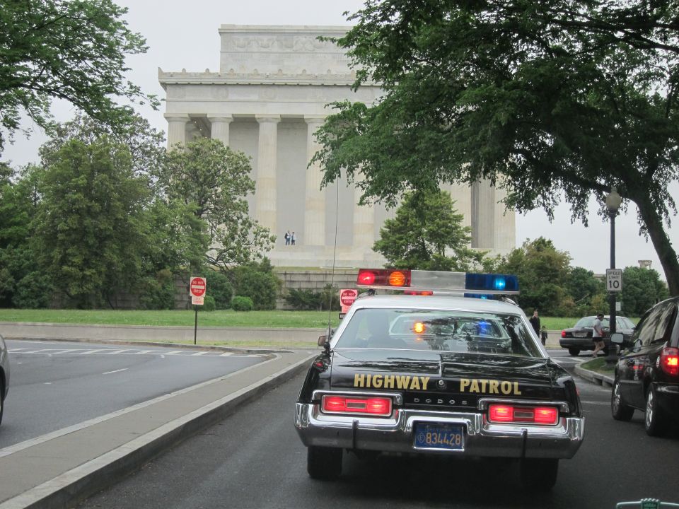 Rear of black Dodge Highway Patrol car parked before the Lincoln Memorial
