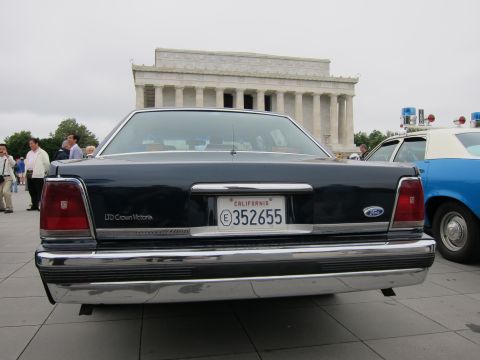 1991 Ford LTD Crown Victoria - chrome-bumpered rear of a dark blue Ford LTD Crown Victoria with California plate sits before the Lincoln Memorial.