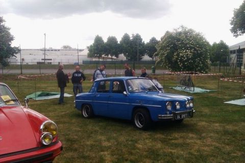 1991 Ford LTD Crown Victoria - A blue sedan is parked on a grassy field with people standing around it.