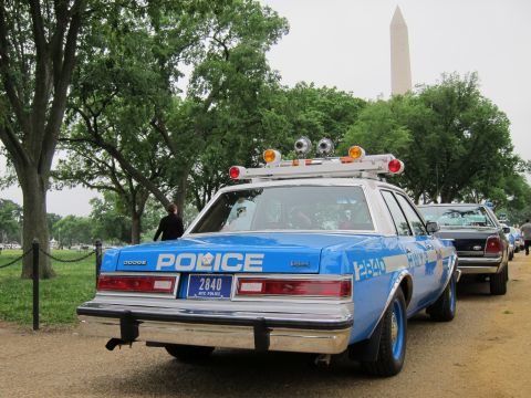1991 Ford LTD Crown Victoria - blue NYPD police sedan numbered 2840 with roof lights, viewed from the rear with the Washington Monument behind it.