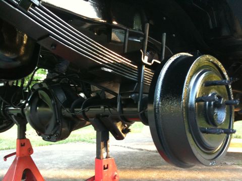 1996 Ford Bronco - Rear axle and suspension components are elevated on jack stands for maintenance or repair.