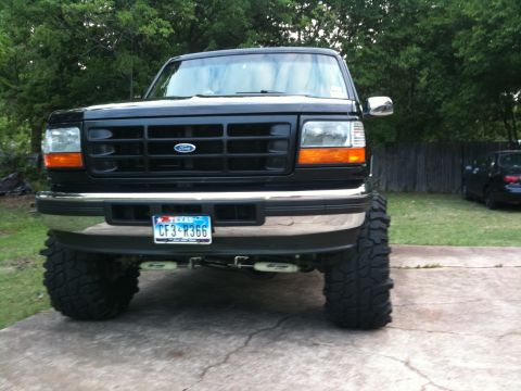 1996 Ford Bronco - Front view of a lifted 1996 Ford Bronco with large tires and a Texas license plate.
